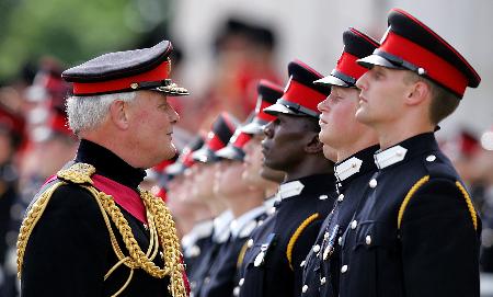 英国陆军参谋长迈克尔·沃克(左)对正在列队的哈里王子(右二)讲话