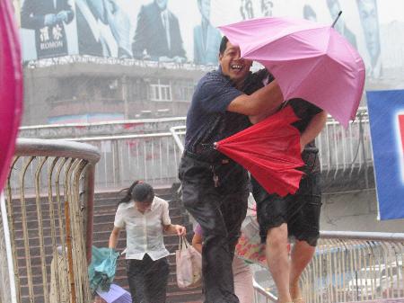 图文：安徽阜阳市市民在风雨中艰难前行