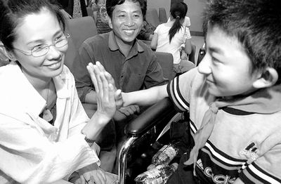 在“5·19希望工程助学公益日”郑州活动现场——助人者击掌鼓励受助小学生