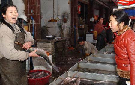 图文:居民在四川大竹县农贸市场买鱼