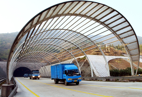 黄鹤山隧道口建起了一个高9米的玻璃大棚遮光罩,为驾驶员进出隧道